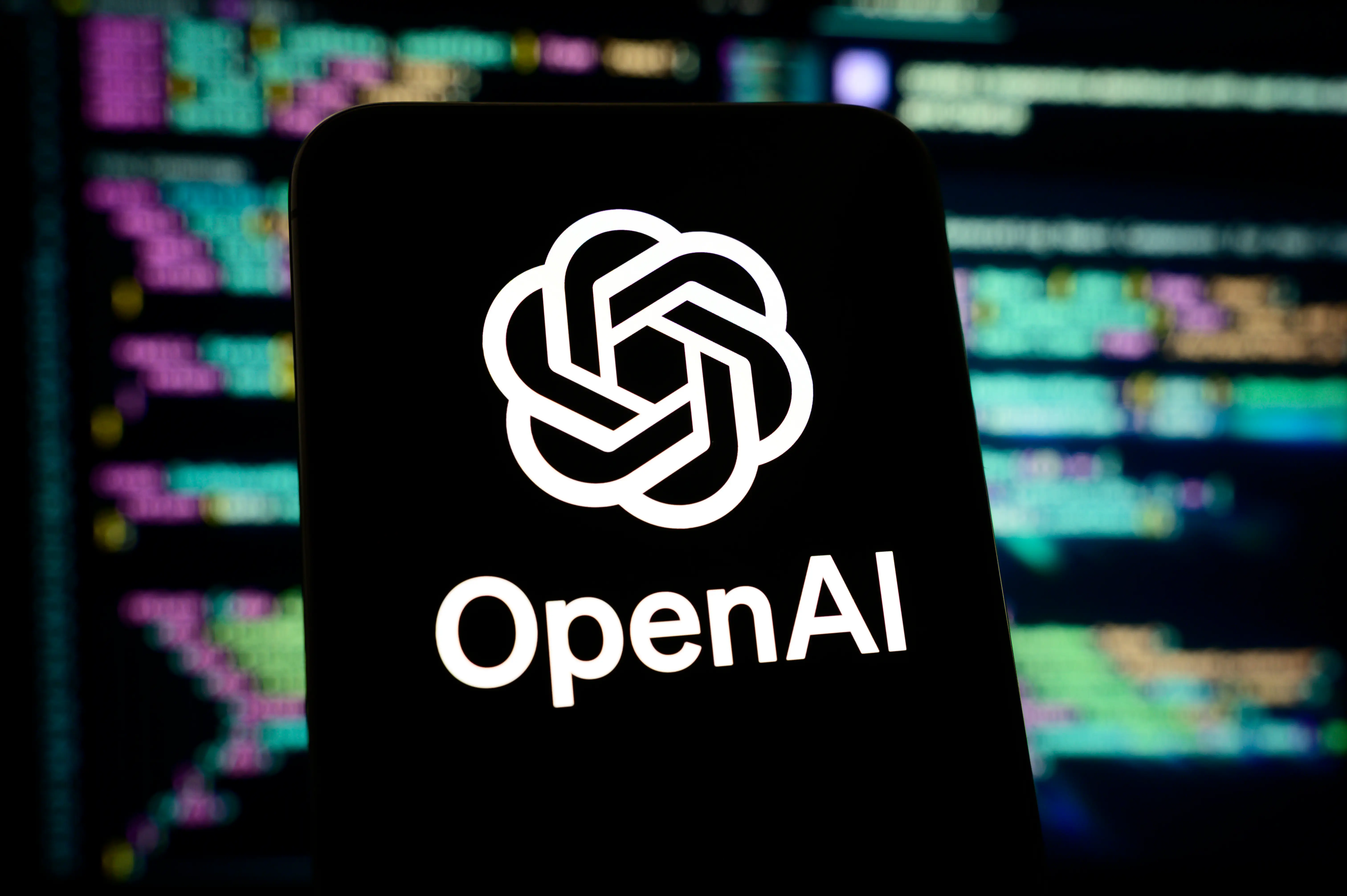 OpenAI's logo against a coding background.