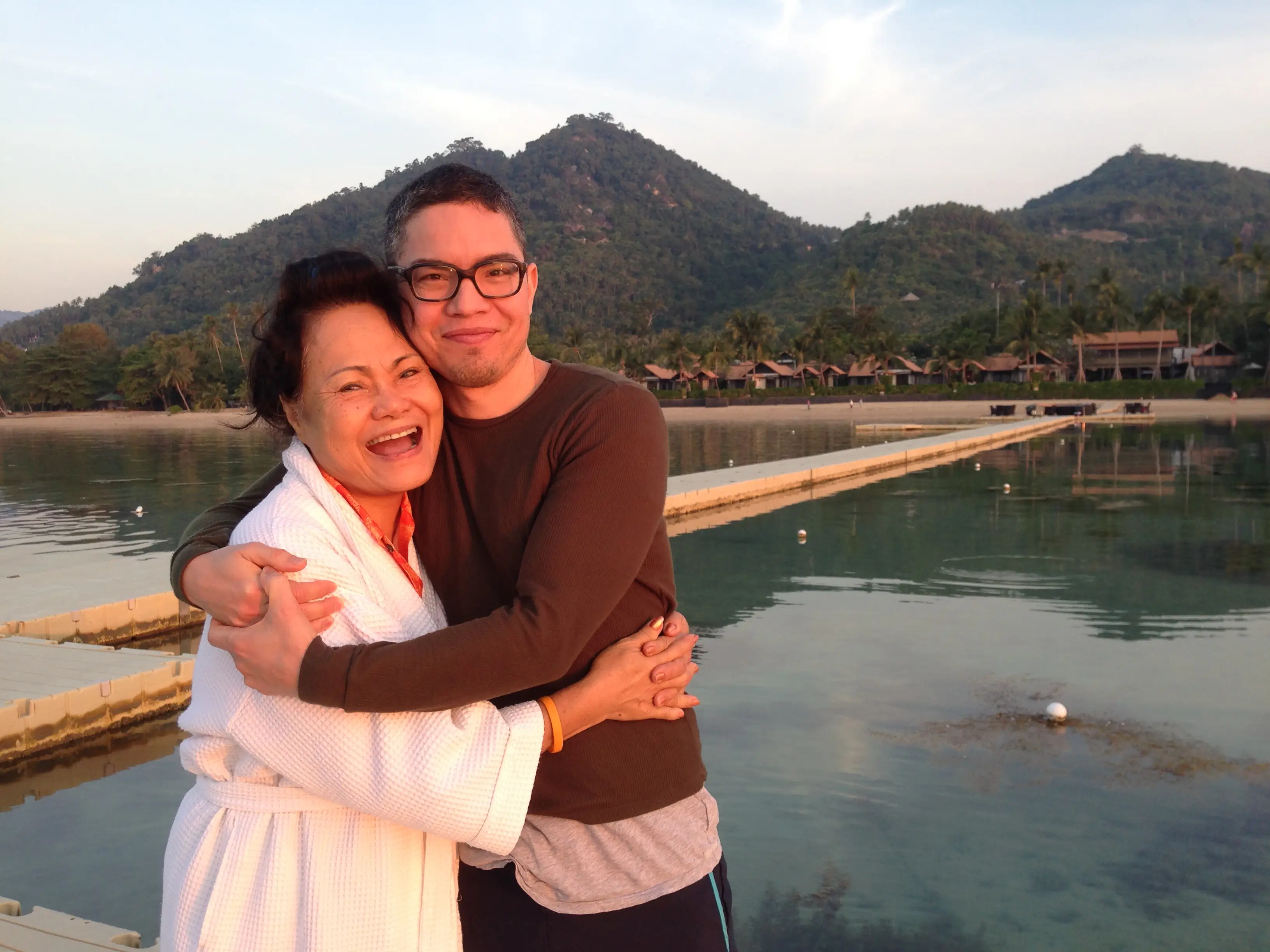 Couple hugging by the water in Koh Samui, Thailand.