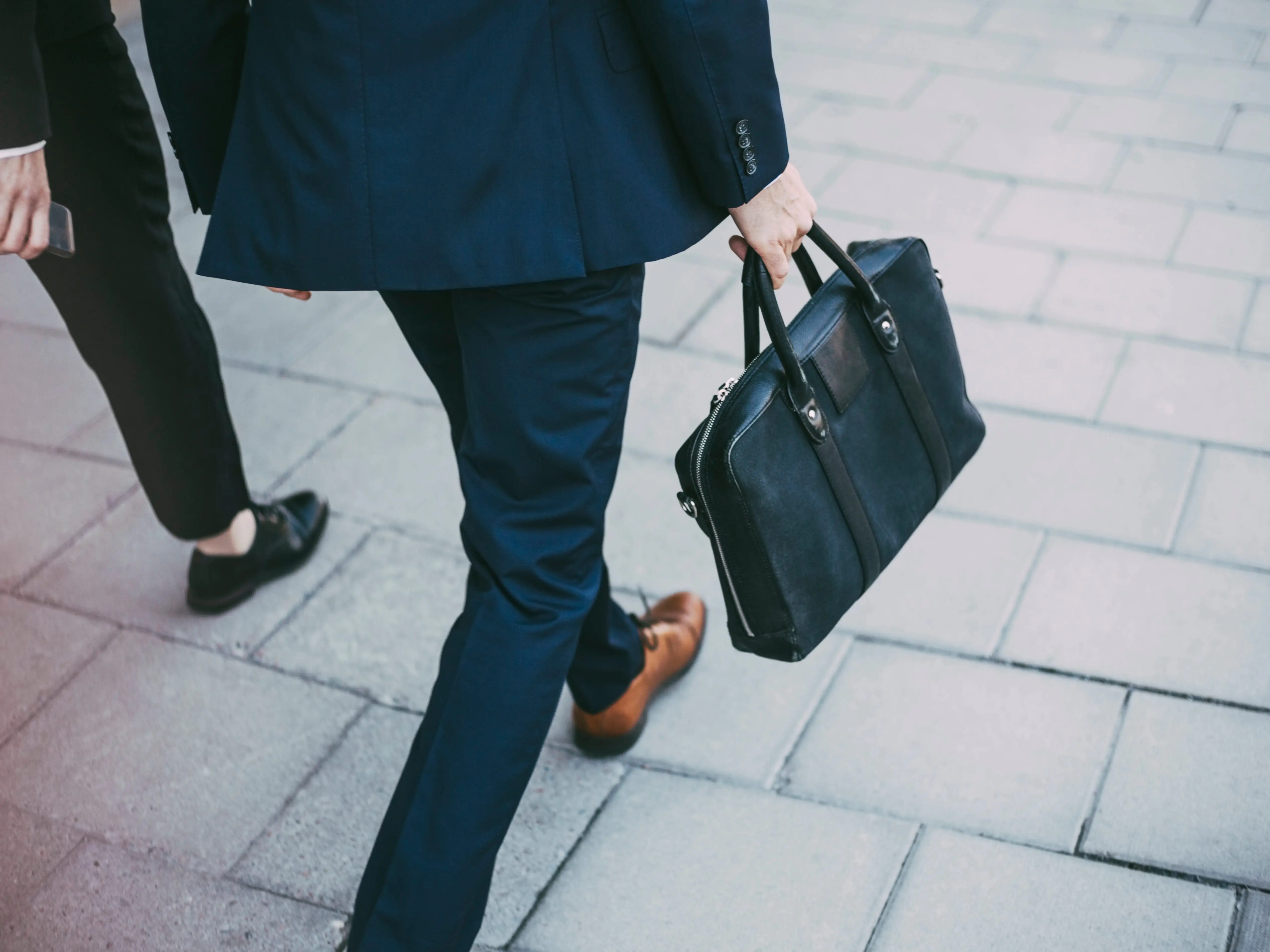 Person walking with briefcase