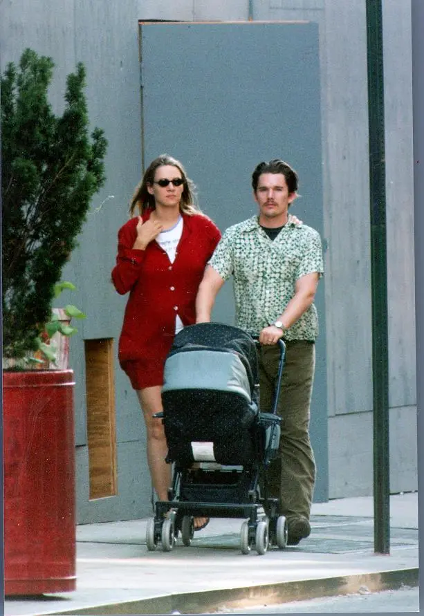 Ethan Hawke and Uma Thurman pushing a stroller.