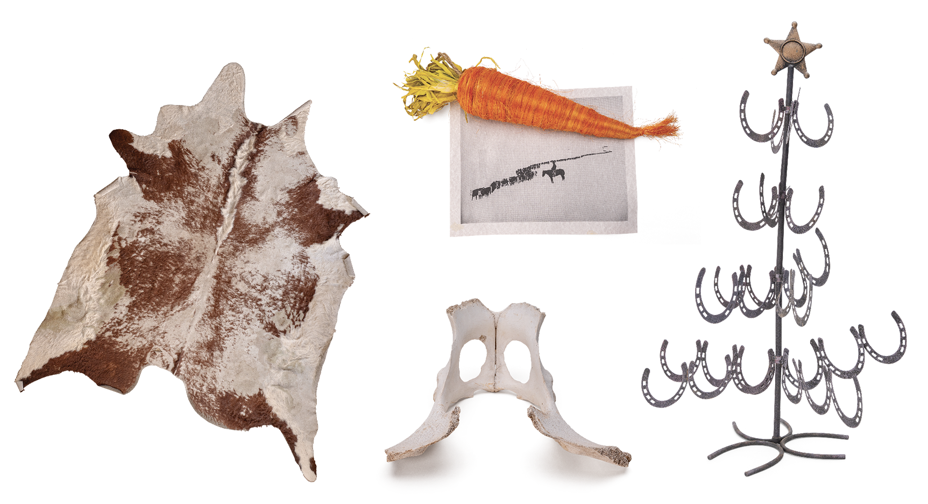 photos of cowhide rug, black-and-white photo print under orange straw carrot, metal holiday tree made of horseshoes welded together as branches with star at top, and pelvis bone 