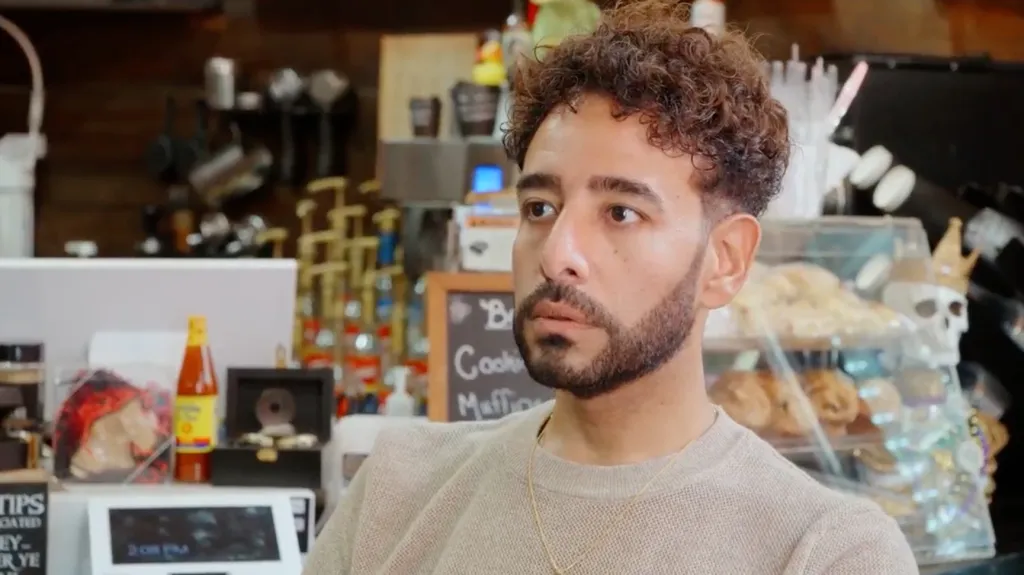 Mido, from 90 Day Fiance, with a concerned expression.