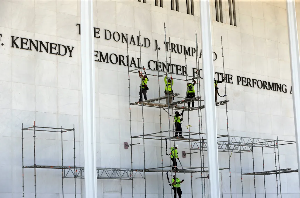 Workers remove letters that spelled 