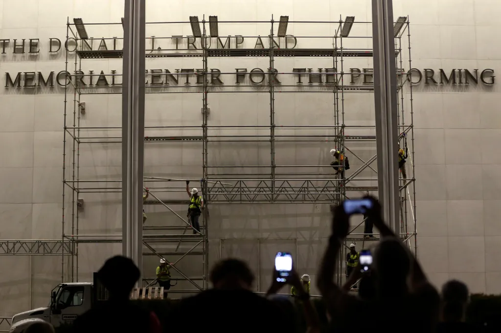 Workers remove letters spelling 
