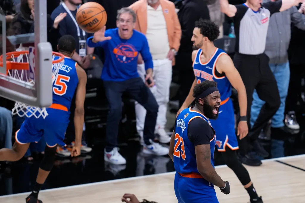 New York Knicks players and fans react to a play during a basketball game.