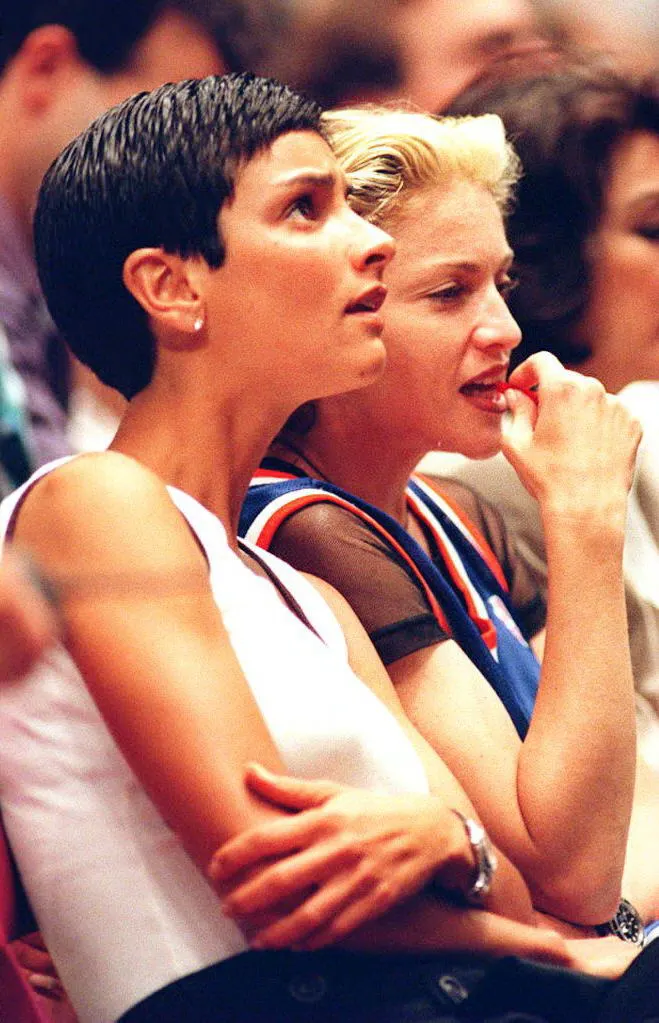 Singer Madonna (R) and an unidentified friend watch the scoreboard during the fourth quarter of Game four of the NBA Finals 15 June 1994 at Madison Square Garden in New York.