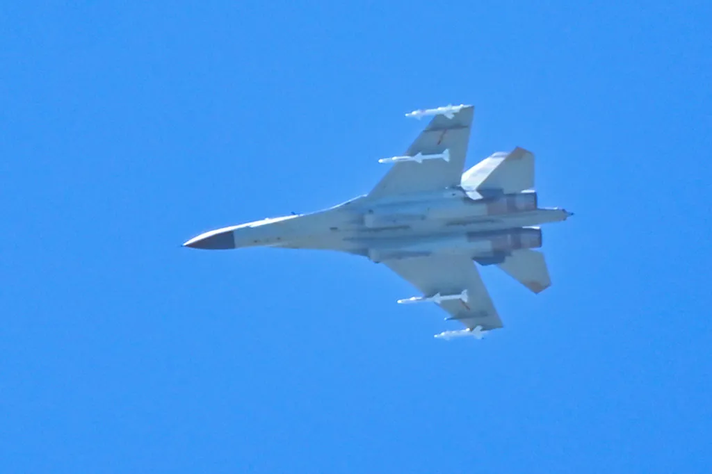 A Chinese military jet flies over Pingtan island, one of mainland China's closest point from Taiwan, in Fujian province on August 5, 2022