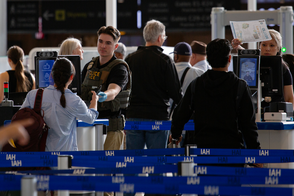 Travelers wait in line of a TSA checkpoint at George Bush Intercontinental Airport in Houston, Texas, on March 28, 2026.