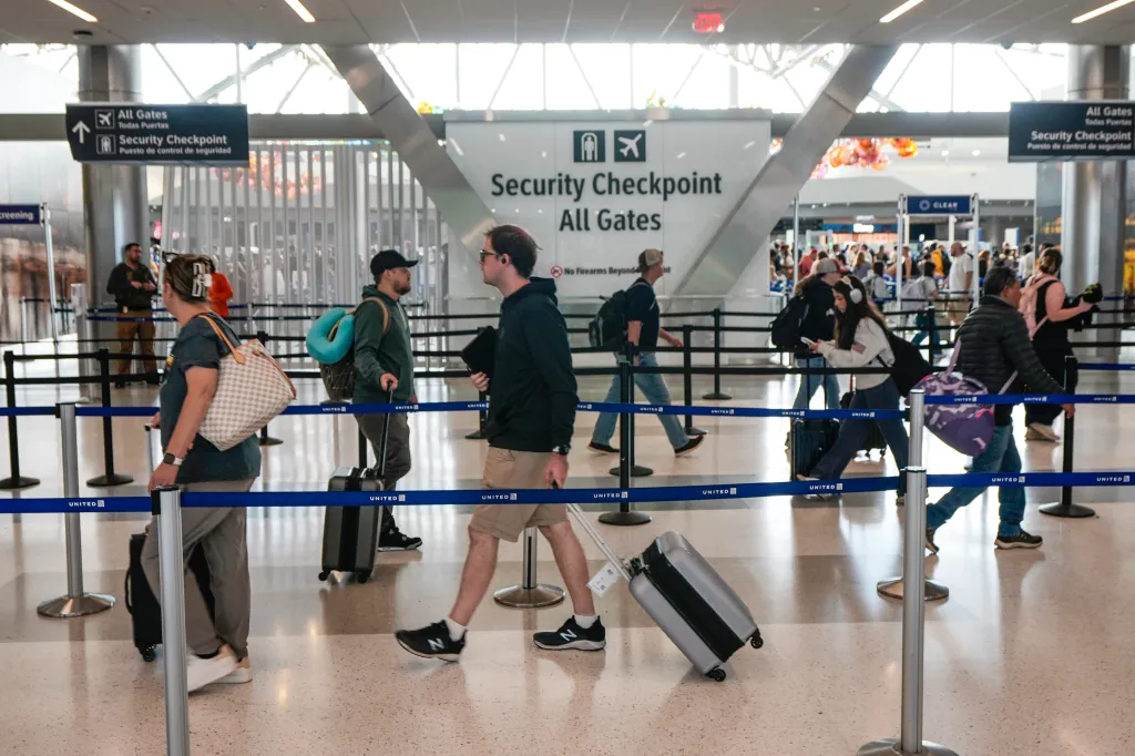 Travelers walk through a security line in Terminal E at George Bush Intercontinental Airport on March 29, 2026.