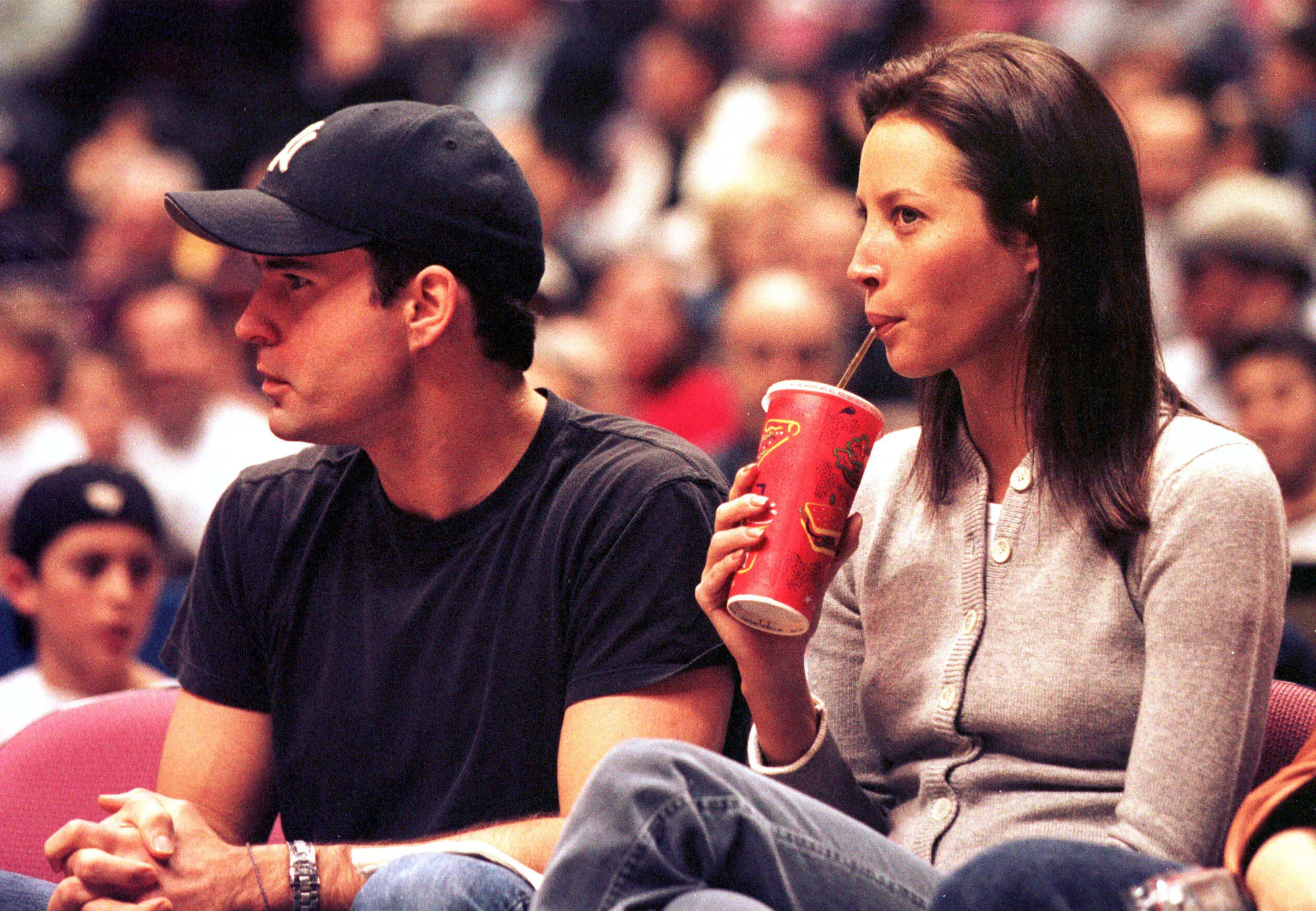 Jason Patric and supermodel Christy Turlington enjoy the view from their front row seats at the New Jersey Meadowlands for a New York Knicks vs New Jersey Nets basketball game on Saturday, December 4, 1999.