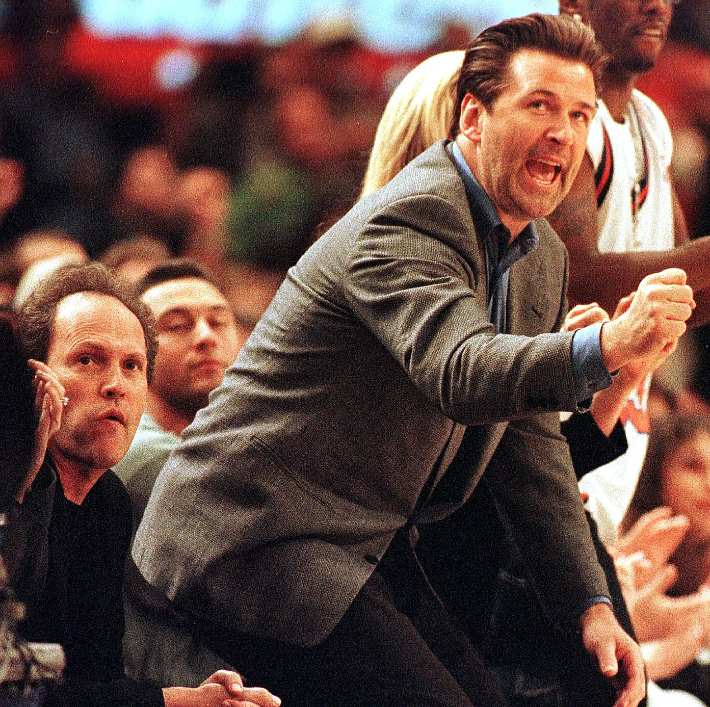Actor Alec Baldwin jumps out of his seat to cheer the New York Knicks as they face the Indiana Pacers in the third game of the best of seven Eastern Conference Finals, June 5, 1999, comedian Billy Crystal is seated next to Baldwin.