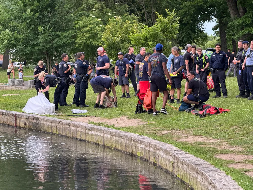 Law enforcement and rescue workers gathered at a canal.