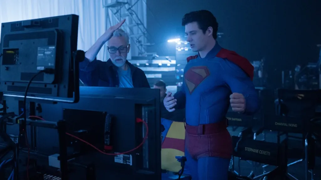 James Gunn speaks to David Corenswet (in costume as Superman) at a monitor while filming 