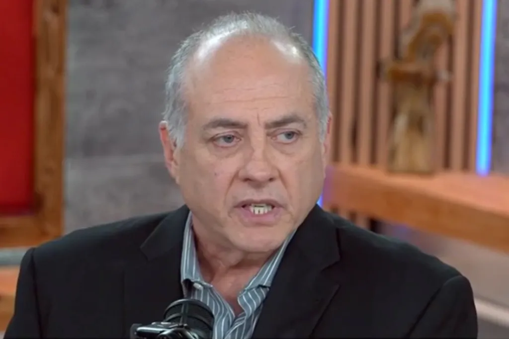 Man speaking into a microphone.