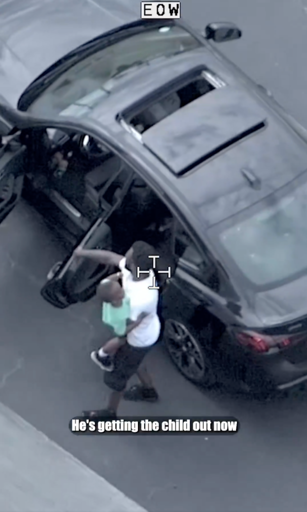 Jason Kenon grabs a child from the back seat of his car during a police pursuit in Florida on June 9, 2026.