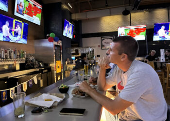 At a UFC watch party, cheers for the fight and dismay over the war in Iran
