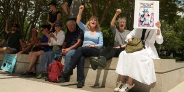 ‘Take it down!’ Crowd electric as workers tear Trump’s name off Kennedy Center