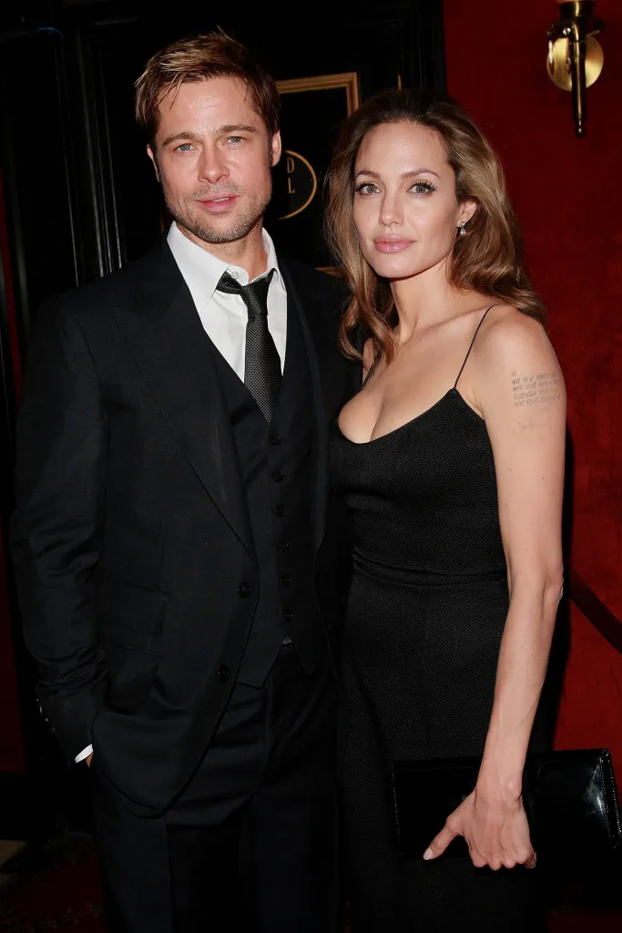 Actors Brad Pitt and Angelina Jolie on a red carpet.