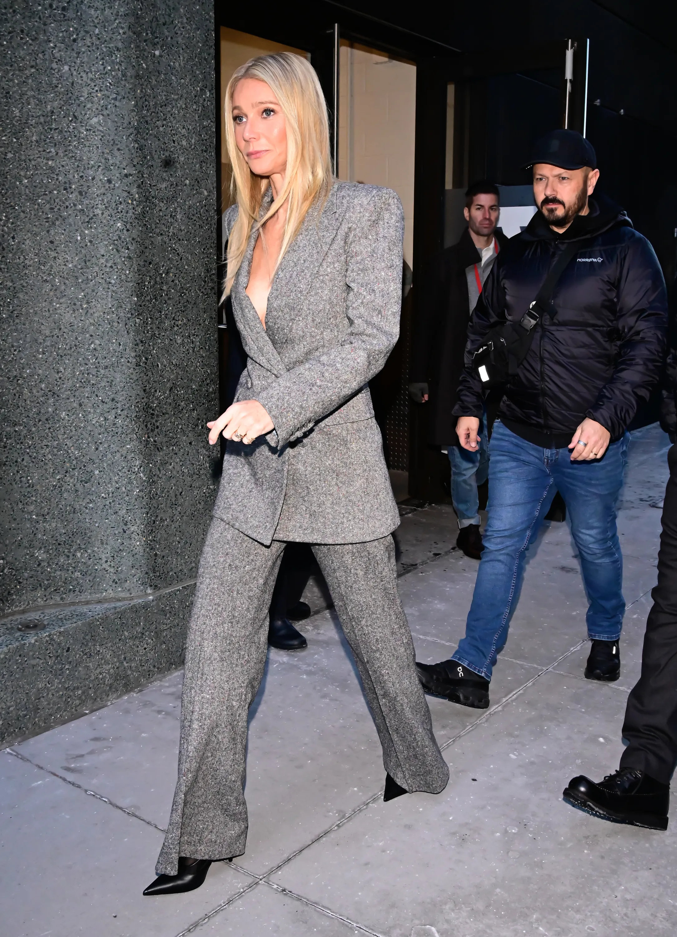 Gwyneth Paltrow in a gray pantsuit arriving at 