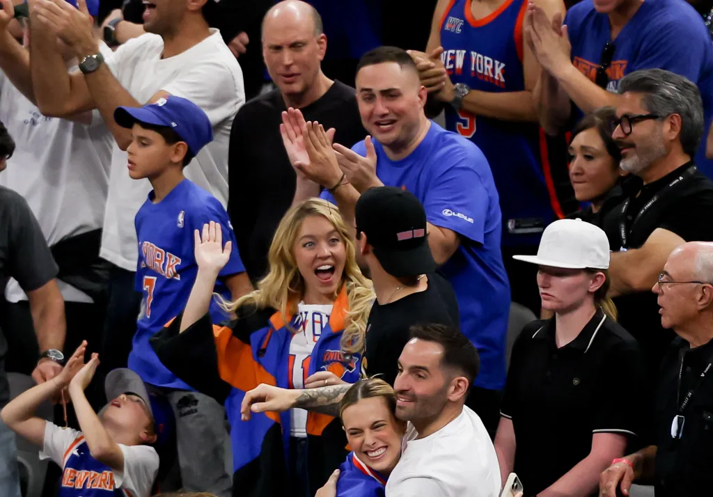 Actress Sydney Sweeney cheering at an NBA Finals game.