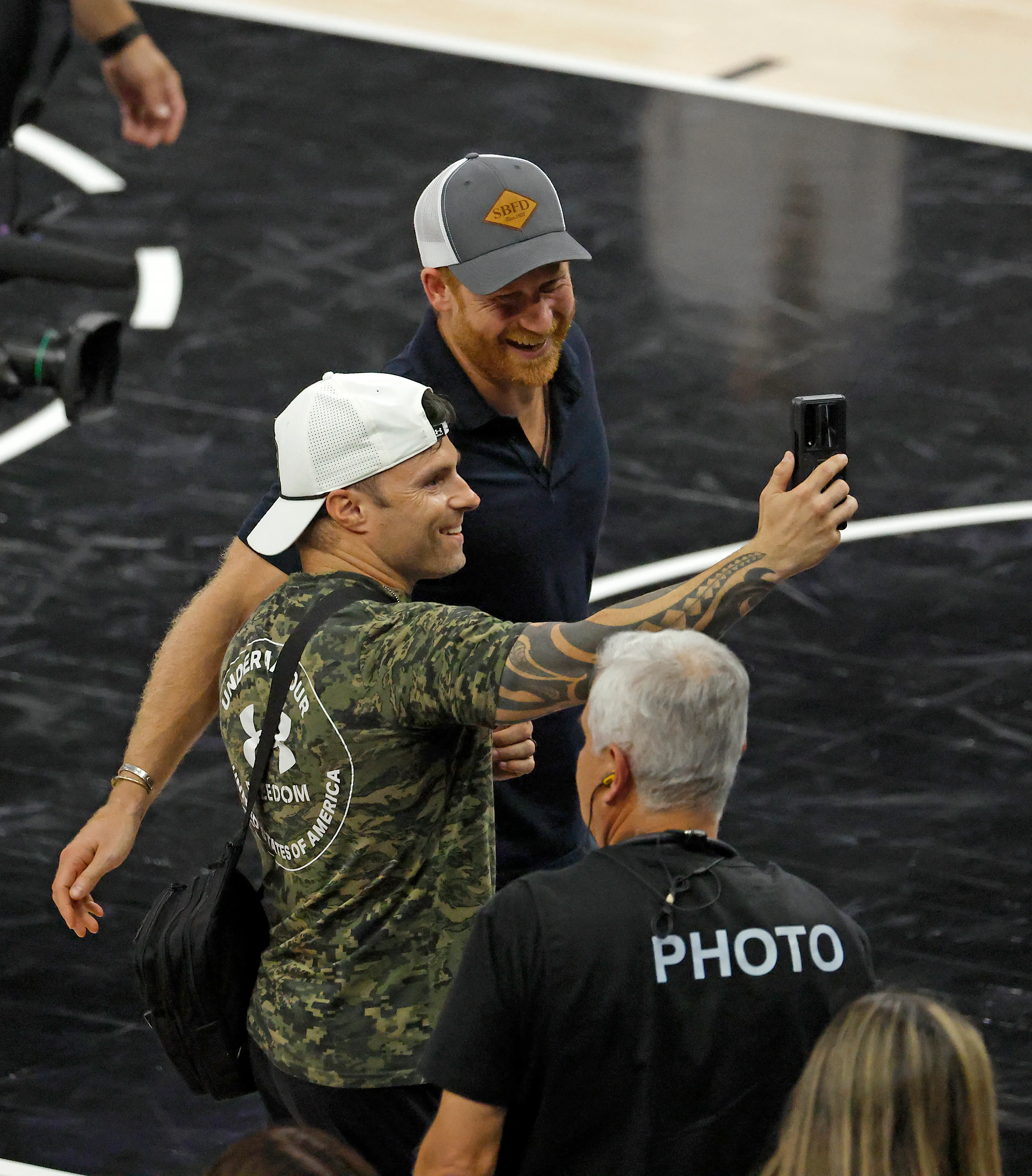 Prince Harry takes a selfie with a fan at the 2026 NBA Finals.