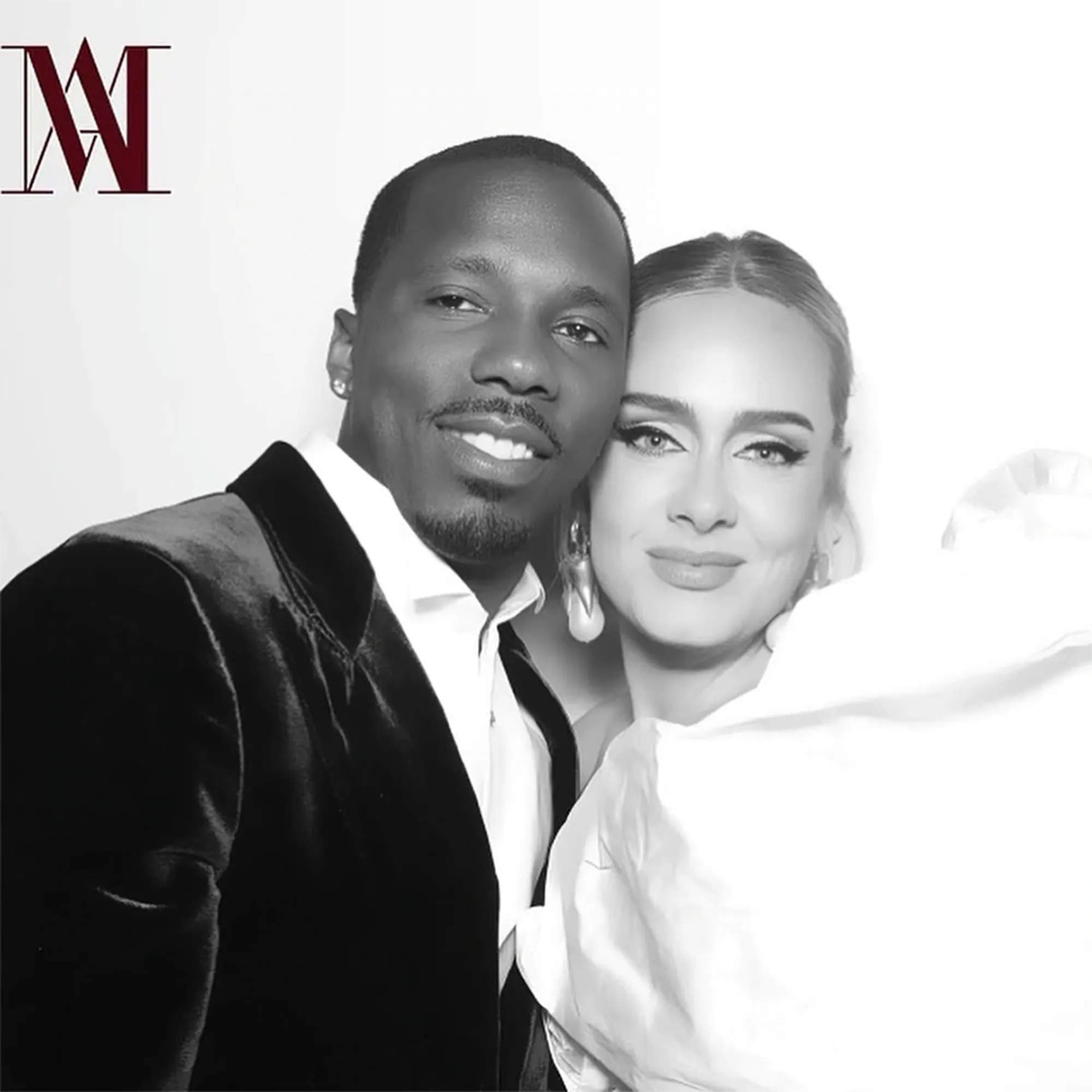 Black and white photo of Adele and Rich Paul smiling at the camera.