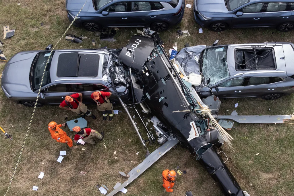 Aerial view of firefighters examining a helicopter wreckage that crashed into parked cars in Rio de Janeiro.