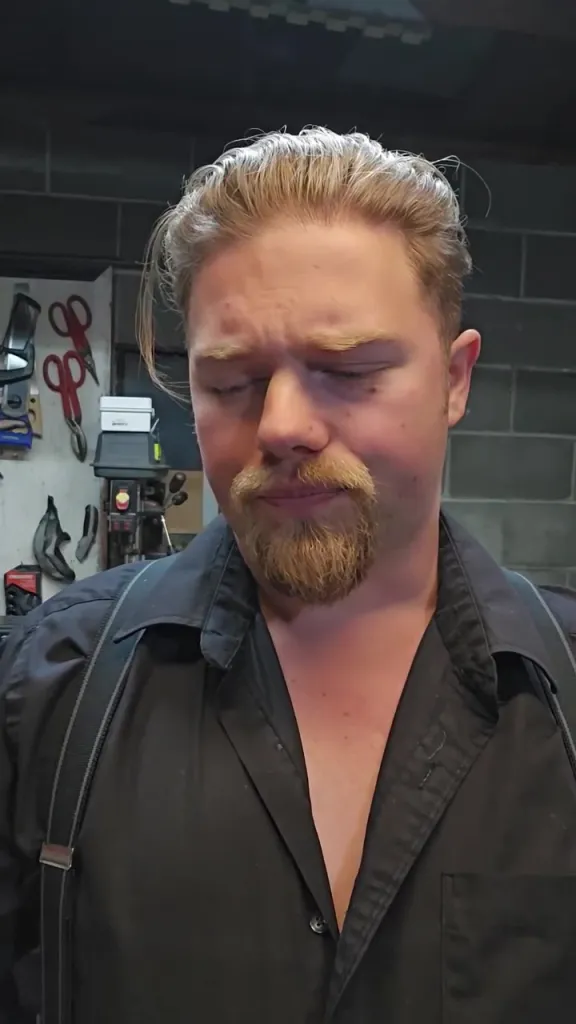 Noah Brown looks downward with his eyes closed, showing an emotional expression.
