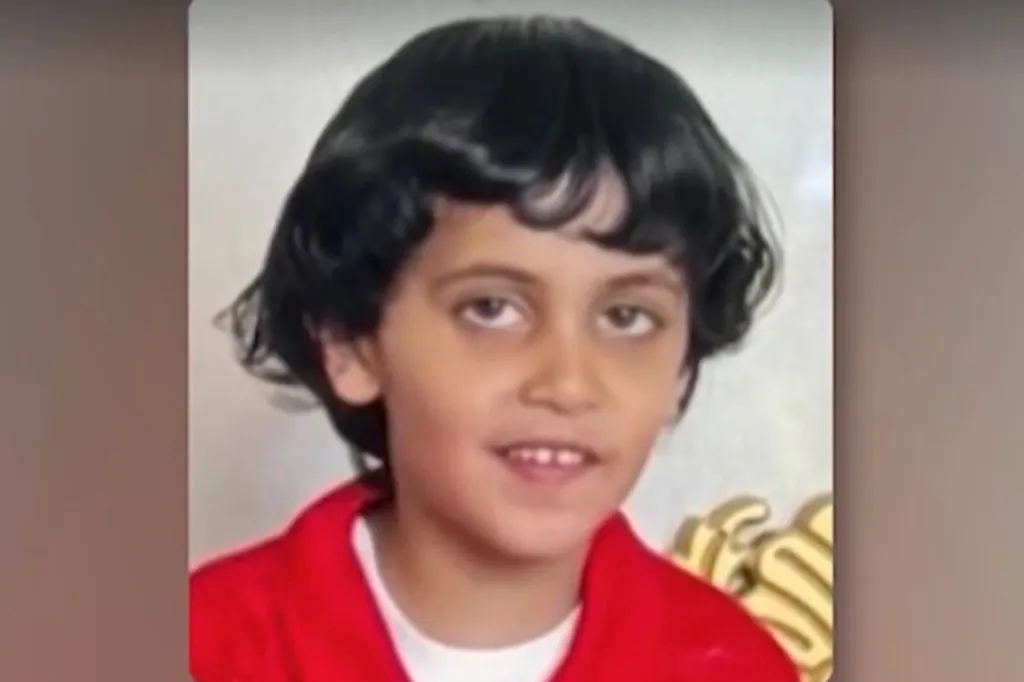 Photo of Harbe Nagi, a missing 7-year-old boy, with dark hair, a red shirt, and a white undershirt.