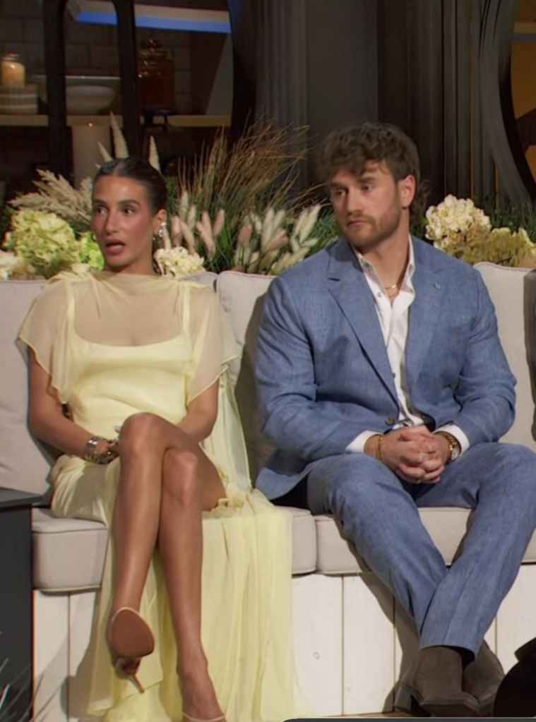 Amanda Batula and West Wilson sitting on a couch.