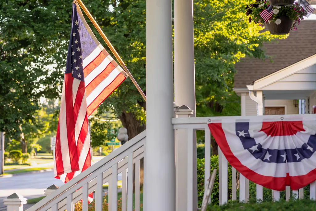 An American flag flying from a porch in Barrington, IL.