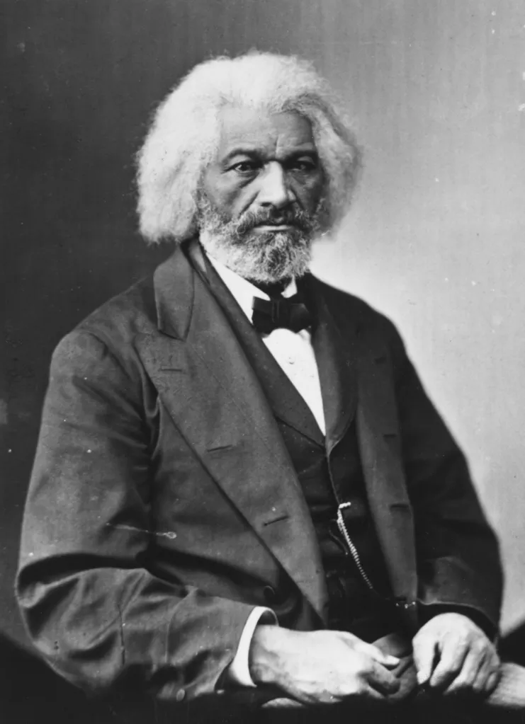 Black and white portrait of Frederick Douglass, an American journalist, author, former slave, and abolitionist, wearing a suit and bowtie.