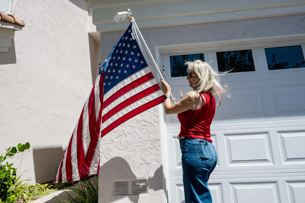 Amy Cooke displays an American flag outside her house.