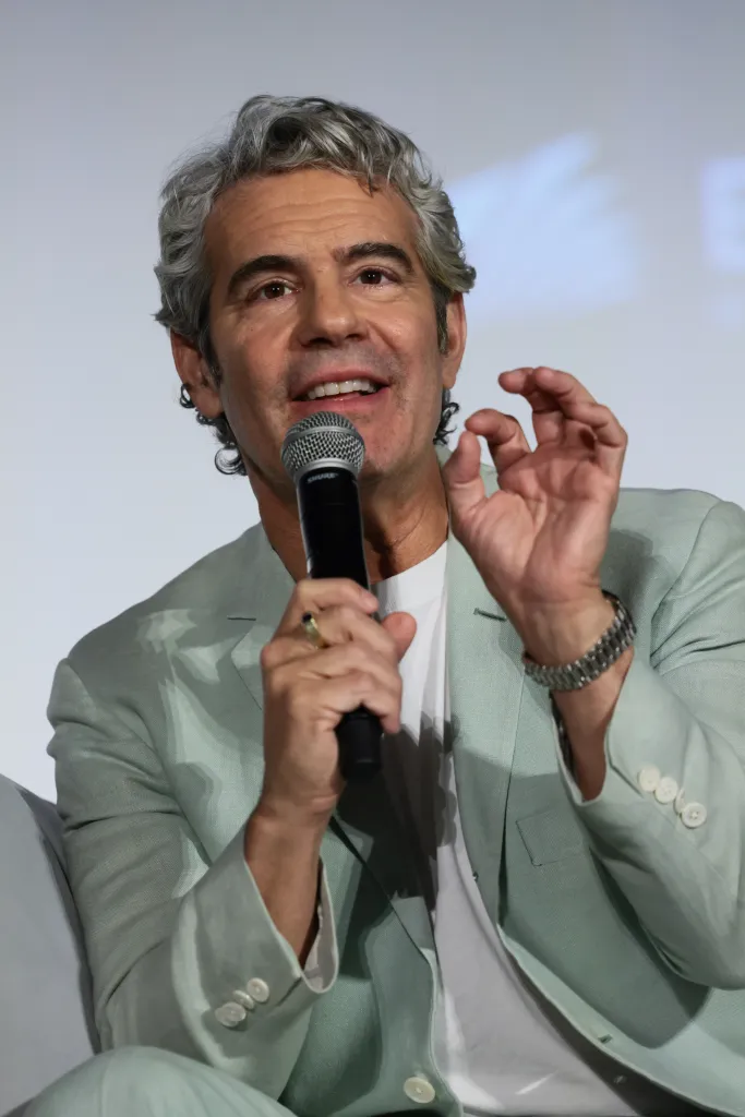 Andy Cohen speaking into a microphone.