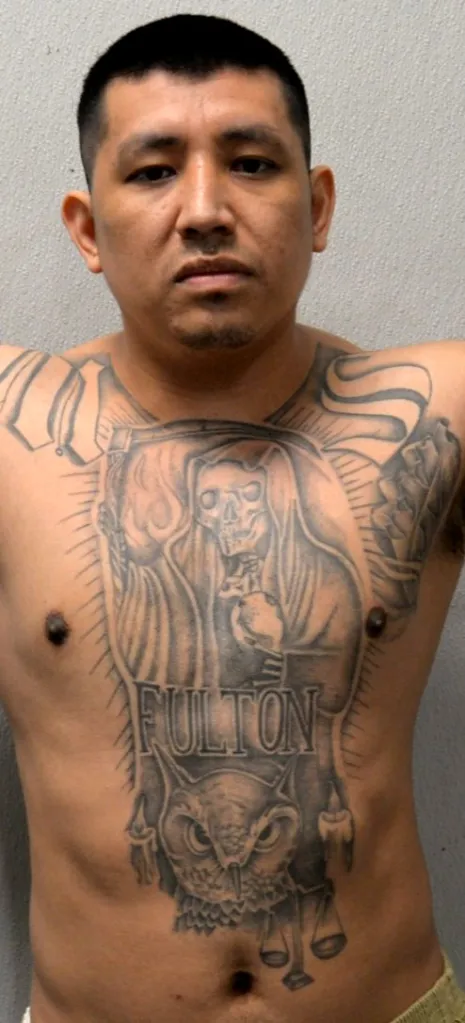 Angel Amadeo Guzman with a chest tattoo of a hooded skeleton, an owl, and 