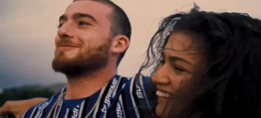 Angus Cloud smiling next to a laughing Zendaya.