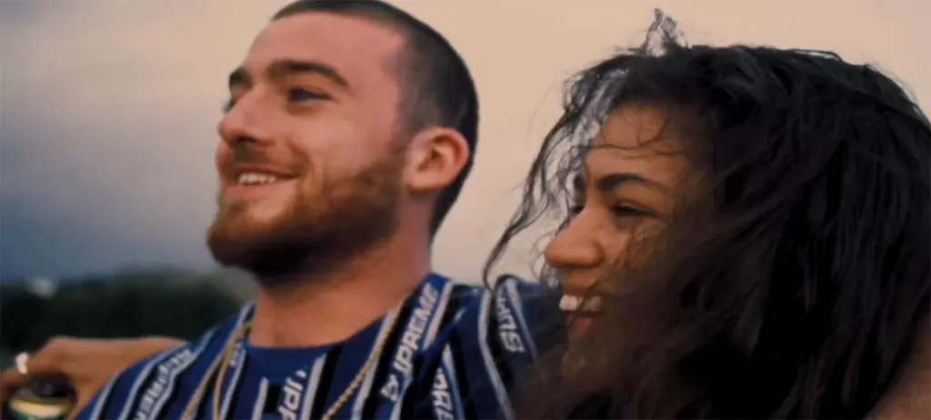 Angus Cloud and Zendaya smiling.