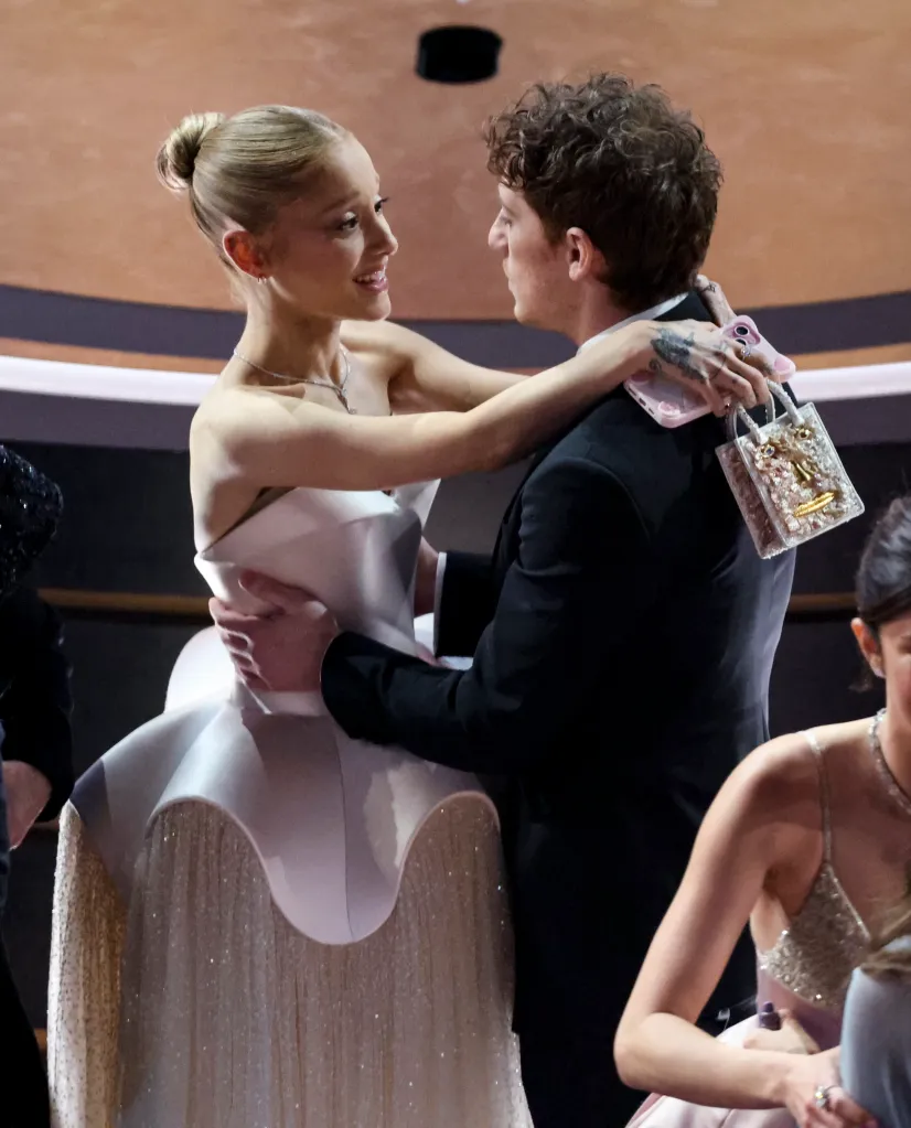 Ariana Grande and Ethan Slater embracing at the 97th Oscars.