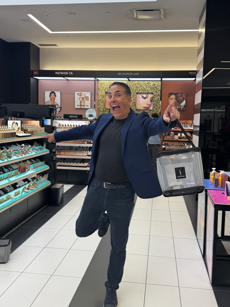 David Rosenblatt posing enthusiastically in a Sephora store.