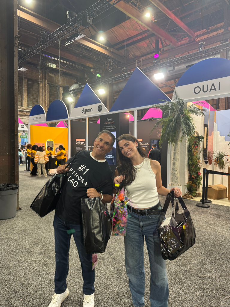 Arielle Rosenblatt and her dad, David, smiling while holding shopping bags at a Sephora event.