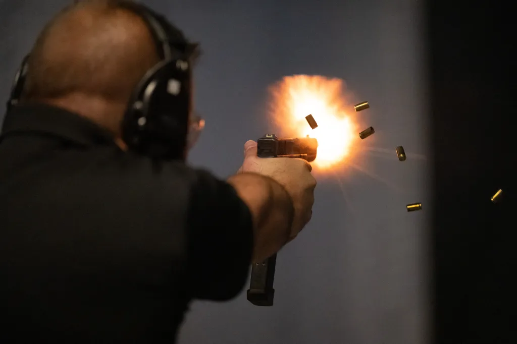 An ATF official fires a semi-automatic gun that has been modified using a a 3D printed gun conversion device that enables a lawful semi-automatic firearm to become an illegal fully automatic firearm with $0.40 worth of plastic
