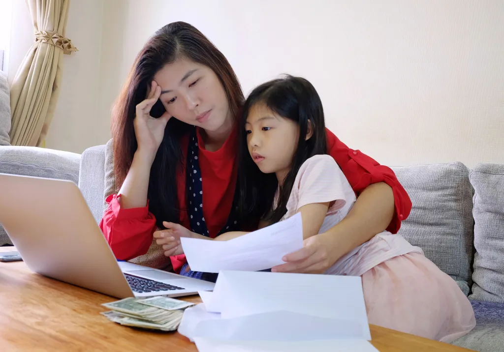 Stressed mom paying bills. 