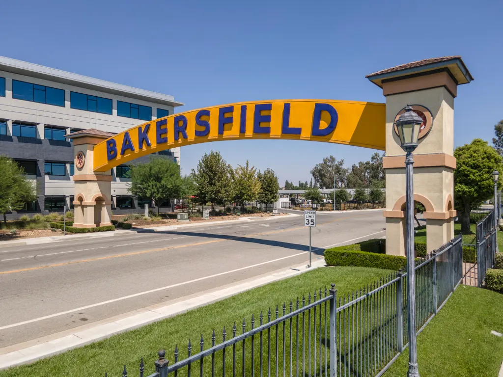 Bakersfield city sign over a road.