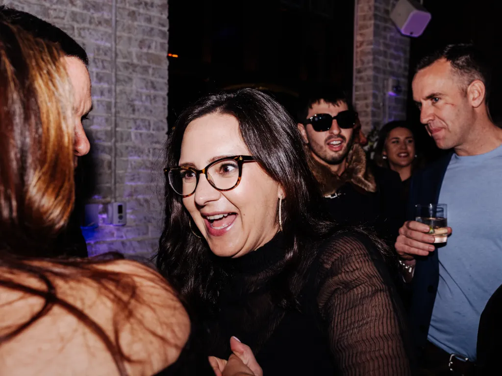 Bari Weiss talks to other attendees at a party.