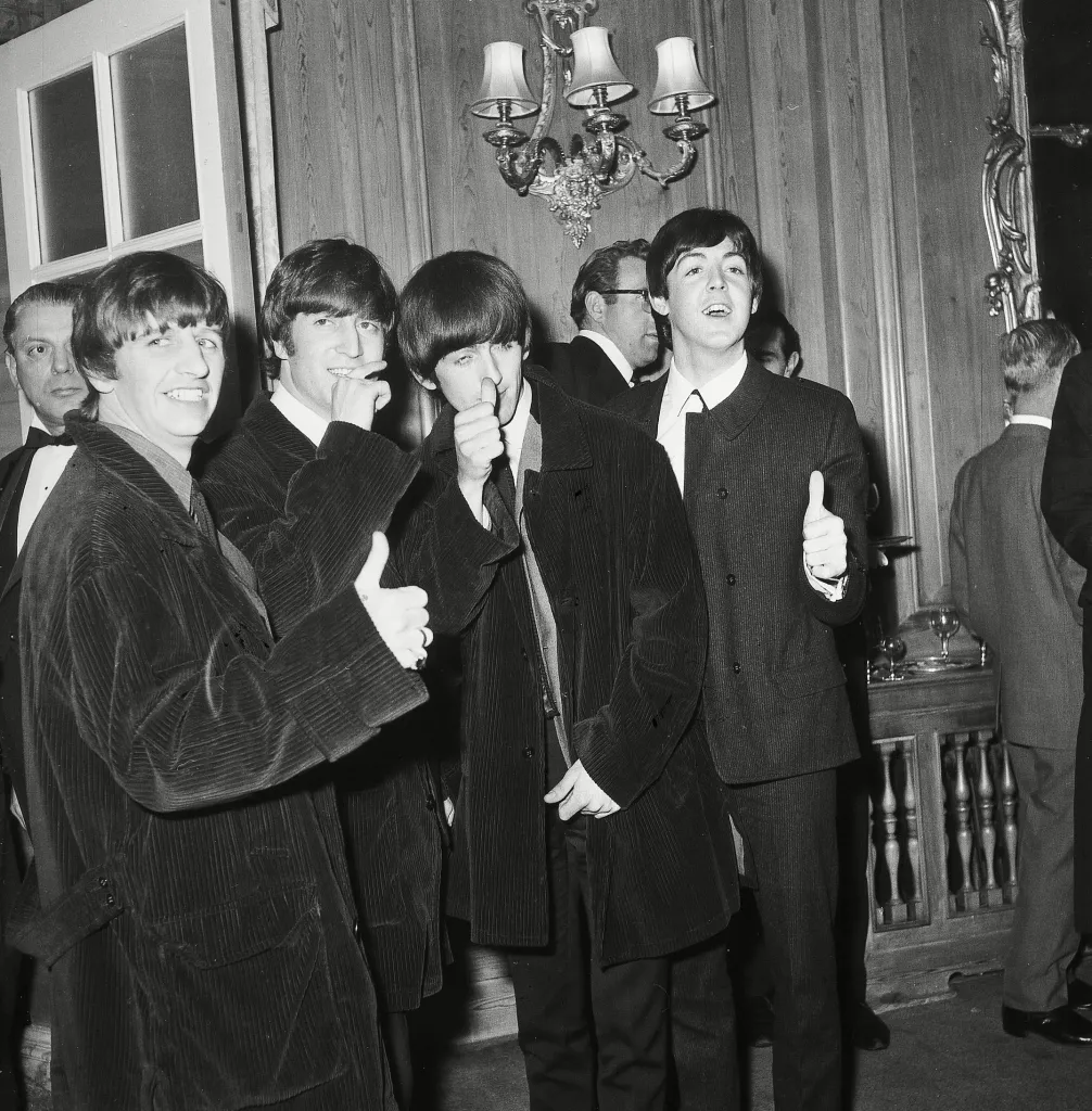 The Beatles (Ringo Starr, John Lennon, George Harrison, and Paul McCartney) giving thumbs up at the Variety Club Luncheon.