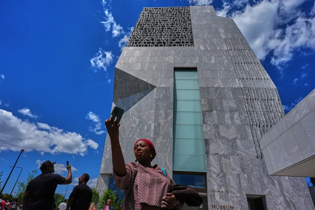 A woman takes a photo of the newly opened Obama Presidential Center in Chicago, Ill. on June 19, 2026. 