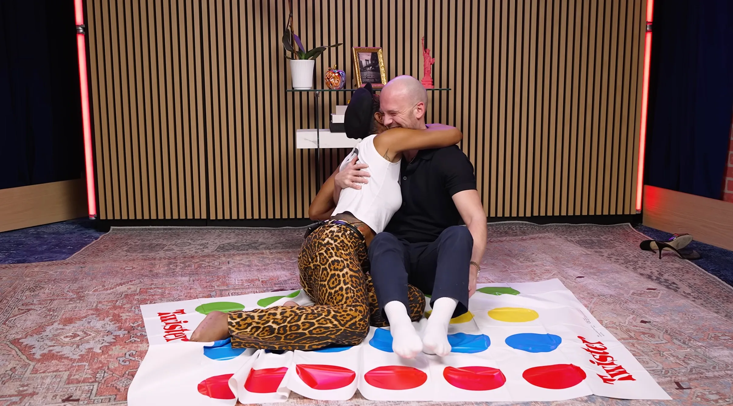 Keke Palmer and Sean Evans playing Twister, embracing.