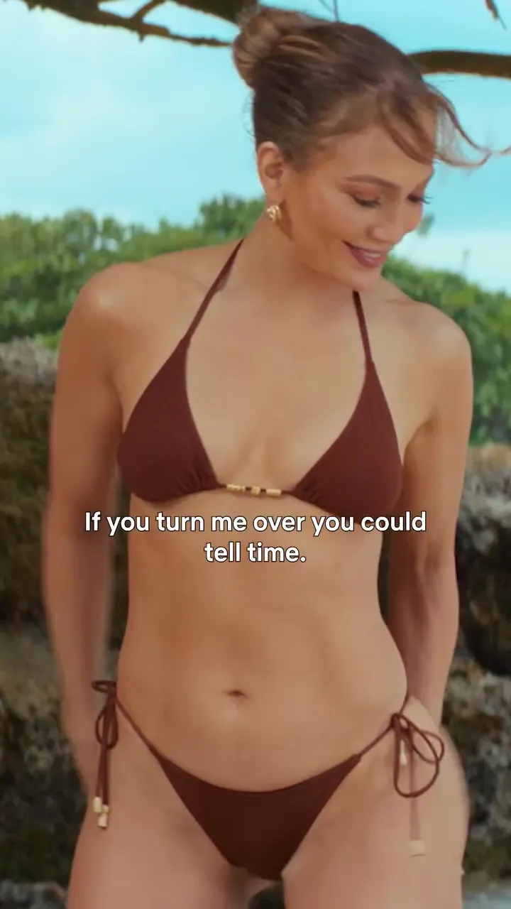 Jennifer Lopez in a bikini on a beach.