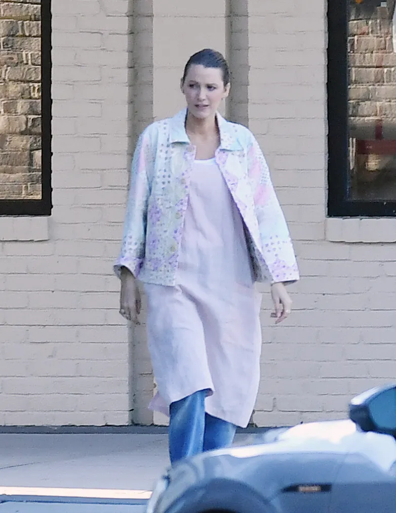 Blake Lively grocery shopping in a patterned jacket, pink dress, and jeans.