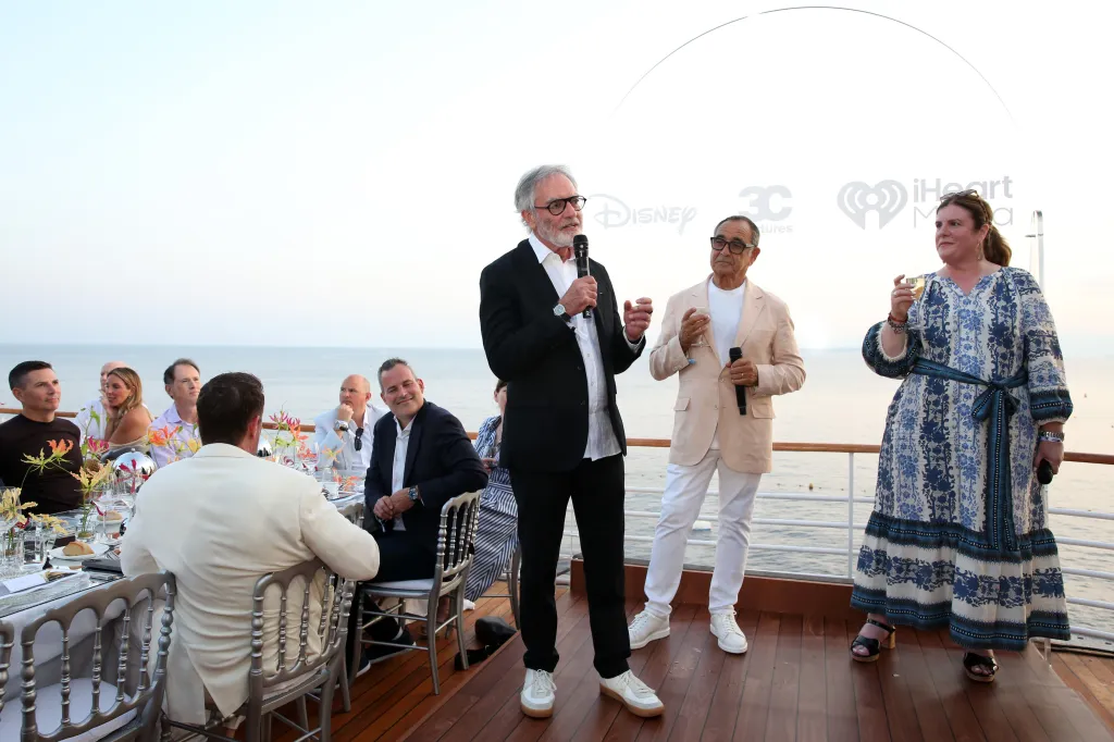 Bob Pittman, Michael Kassan, and Rita Ferro speaking at a VIP dinner at the Cannes Lions Festival.